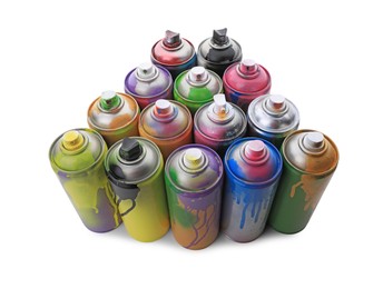 Photo of Used cans of spray paints on white background. Graffiti supplies