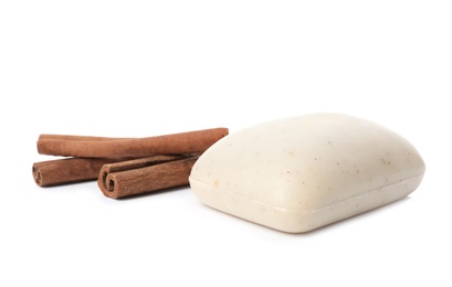 Soap bar and cinnamon sticks on white background