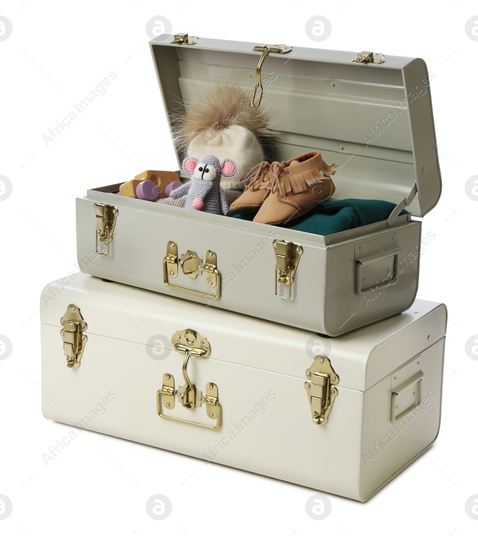 Photo of Stylish storage trunks with child's shoes and toys on white background. Interior elements