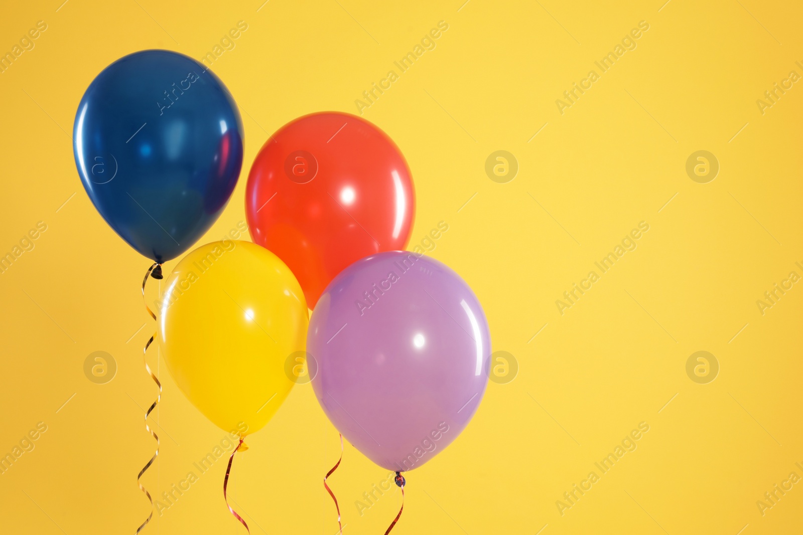 Photo of Bright balloons on color background, space for text. Celebration time