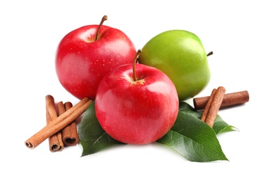 Fresh apples and cinnamon sticks on white background