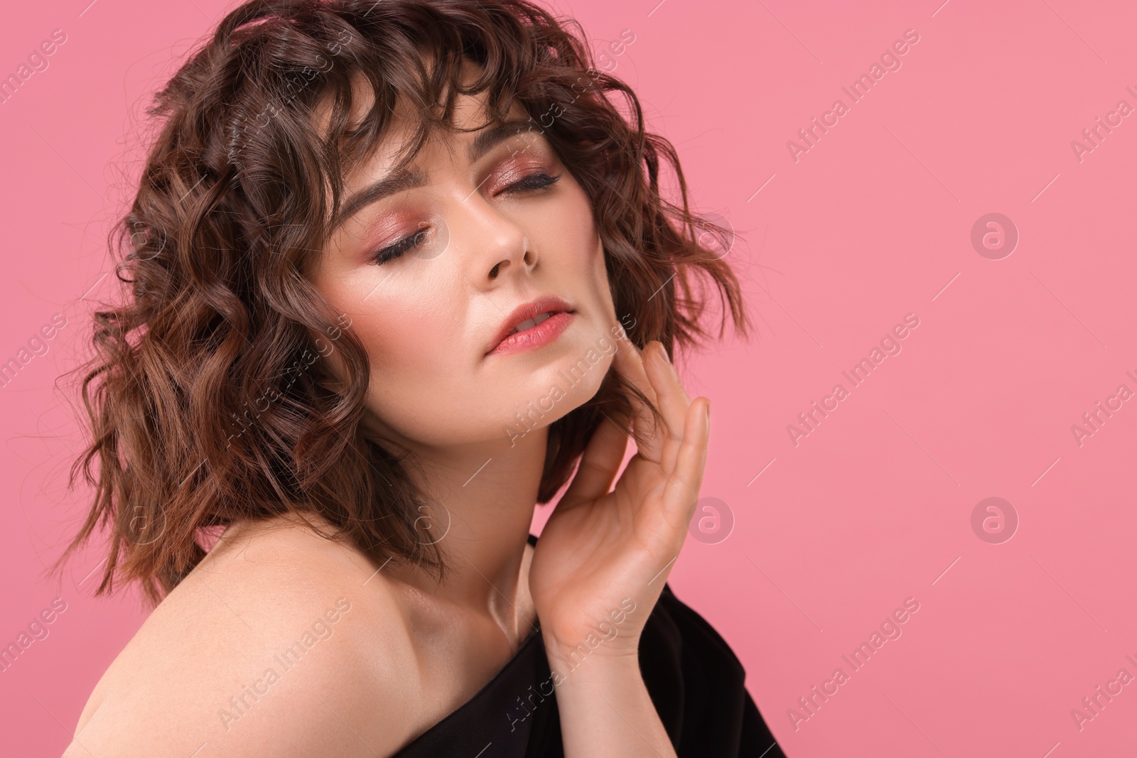 Photo of Portrait of beautiful young woman with wavy hairstyle on pink background. Space for text