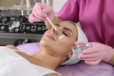 Young woman undergoing cosmetic procedure in beauty salon