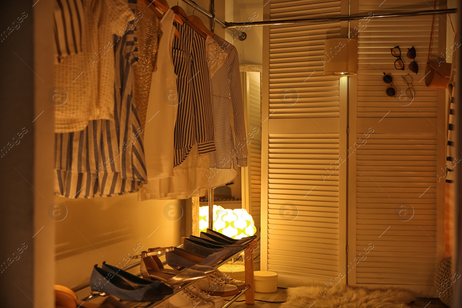 Photo of Modern dressing room with different stylish clothes and accessories