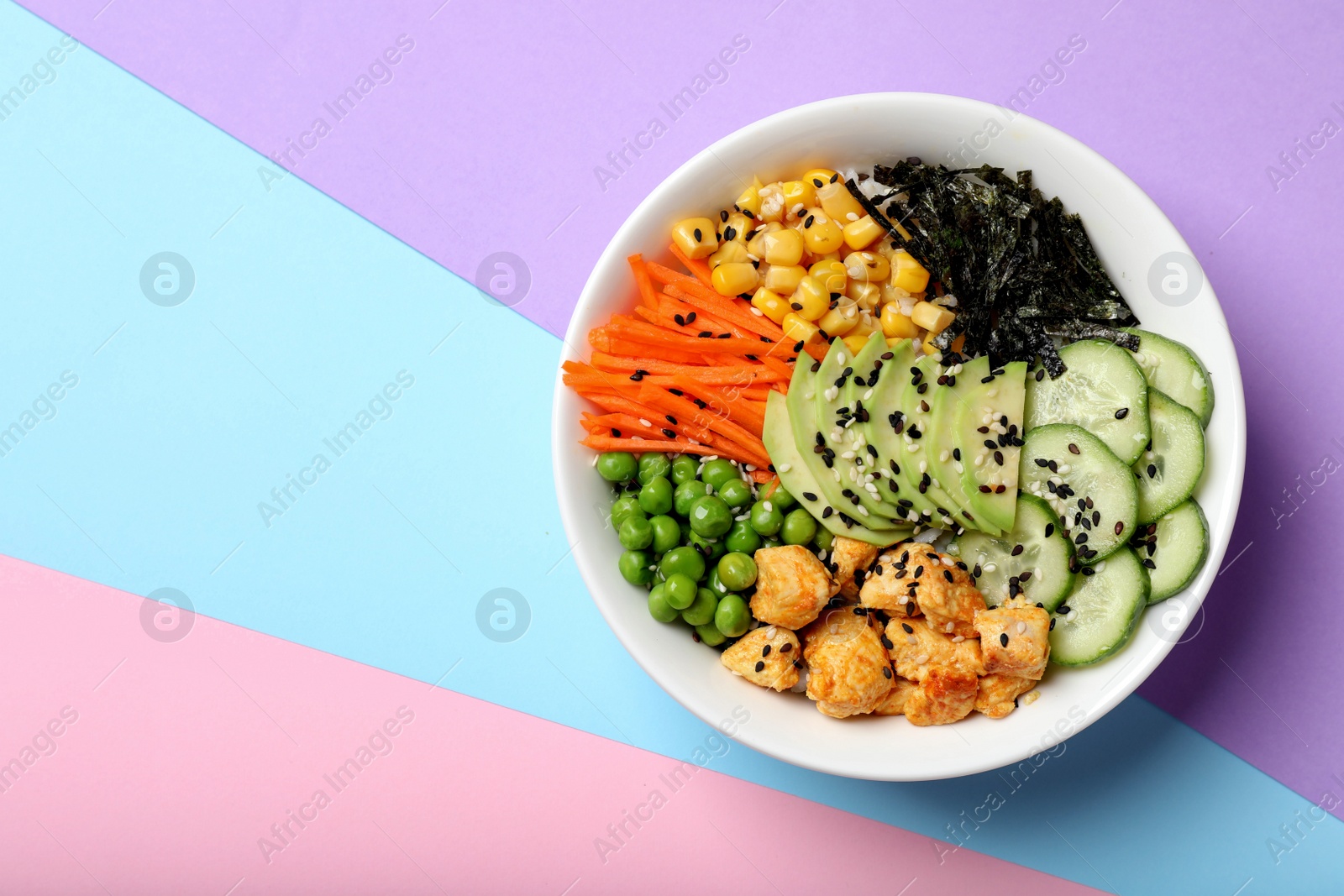 Photo of Delicious salad with chicken and vegetables on color background, top view. Space for text