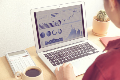 Image of Woman using laptop in office, closeup. Fintech concept