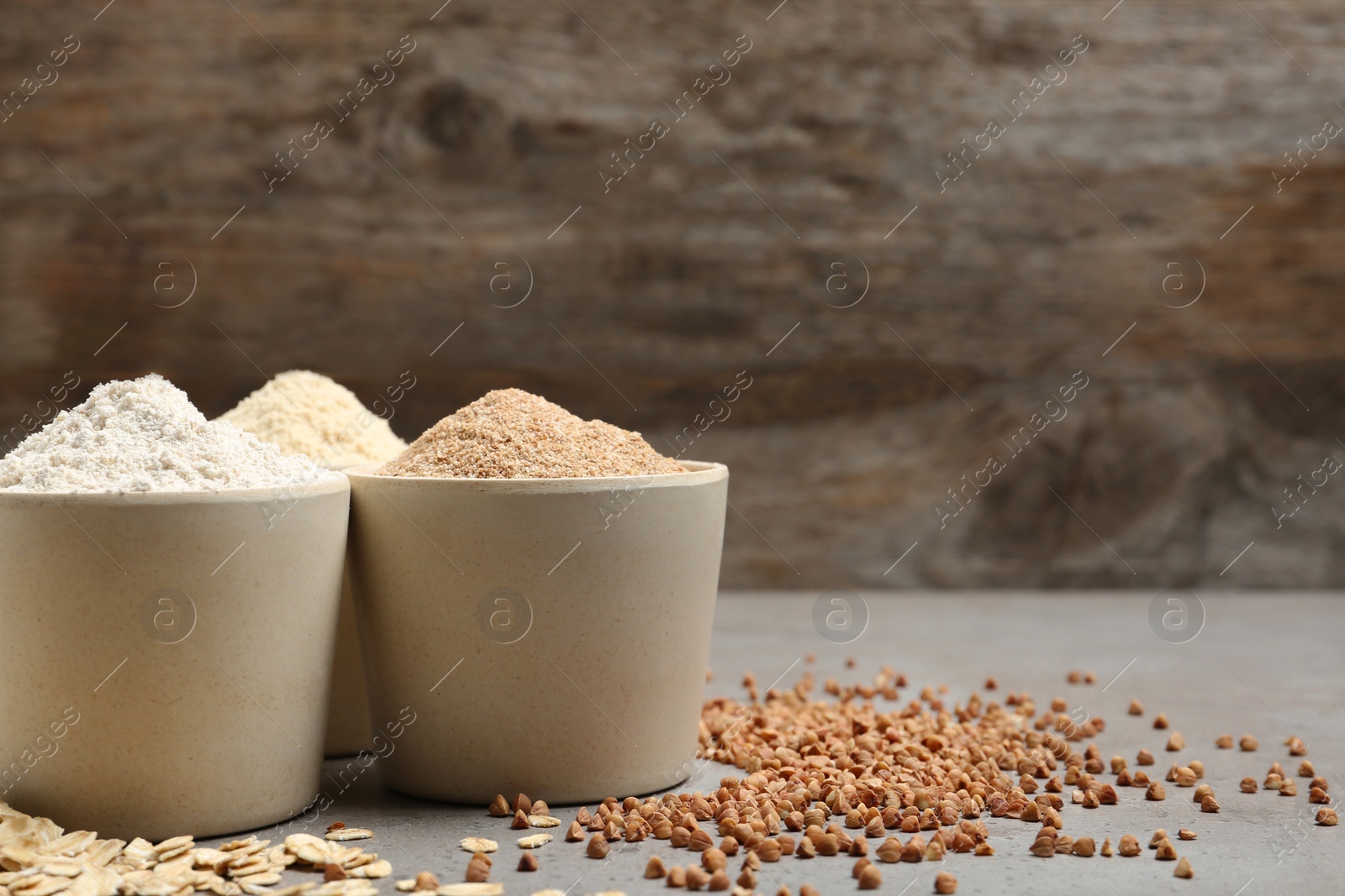 Photo of Composition with different types of flour on table. Space for text