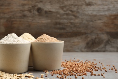 Composition with different types of flour on table. Space for text