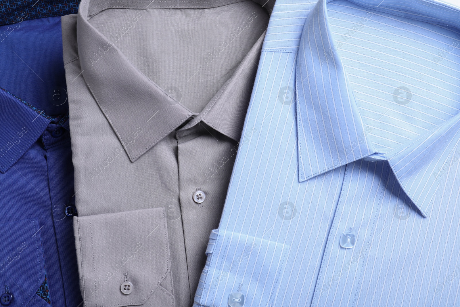 Photo of Stylish shirts as background, top view. Dry-cleaning service