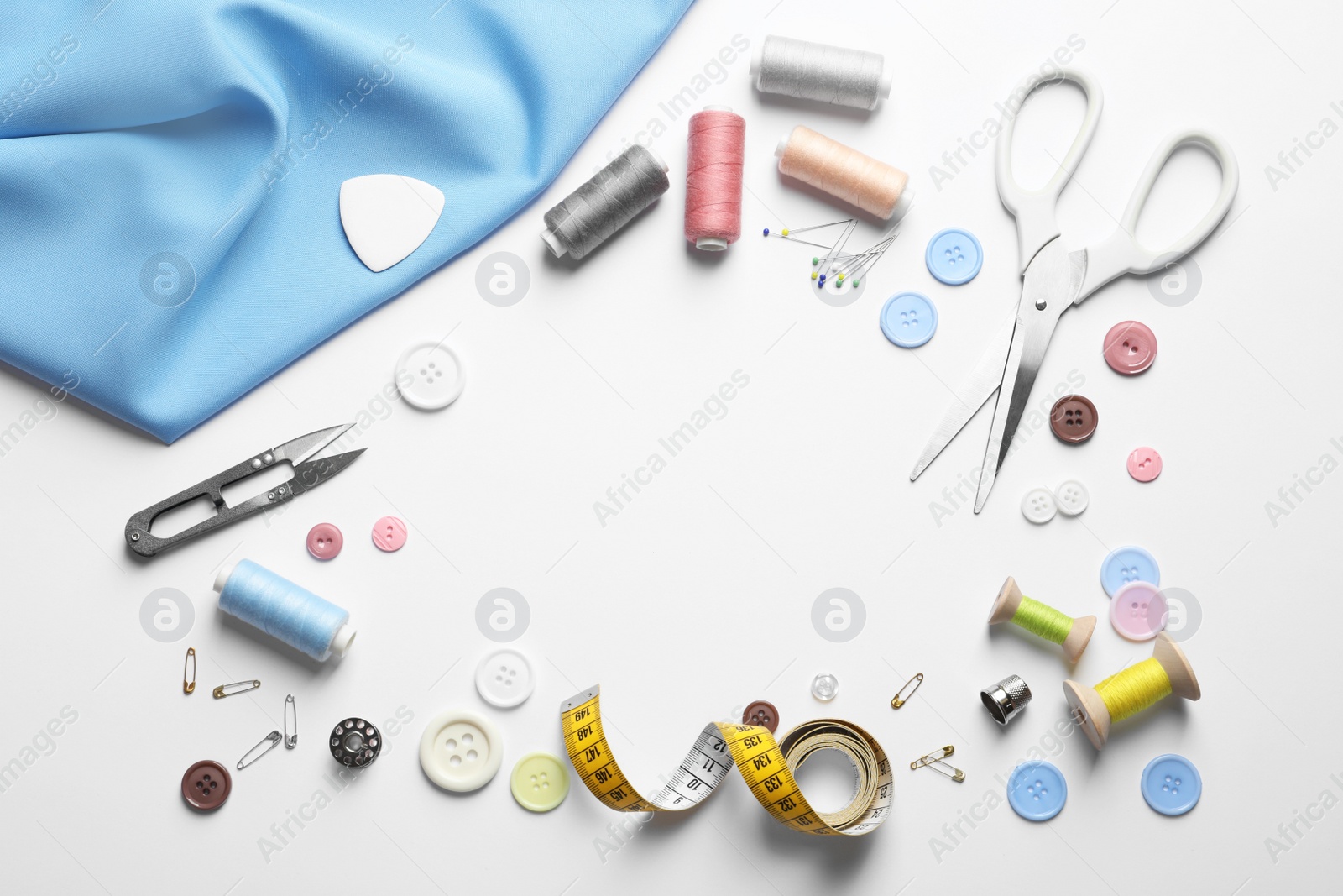 Photo of Flat lay composition with scissors and sewing supplies on white background. Space for text