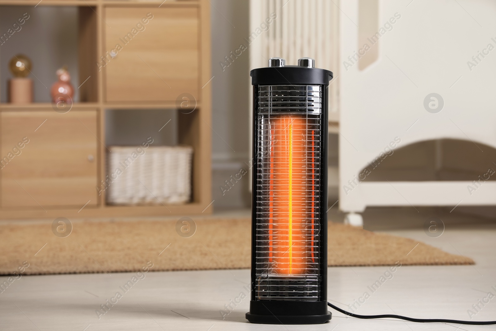 Photo of Modern infrared heater on floor in cozy room. Space for text