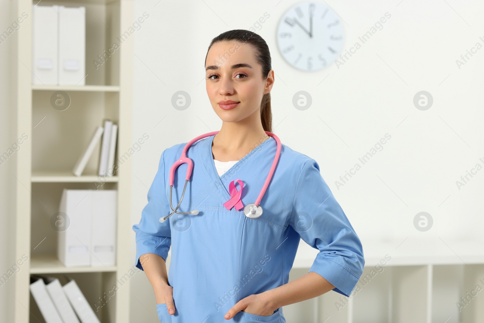 Photo of Mammologist with pink ribbon in hospital. Breast cancer awareness