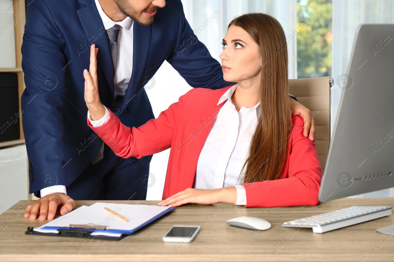 Photo of Boss molesting his female secretary in office. Sexual harassment at work