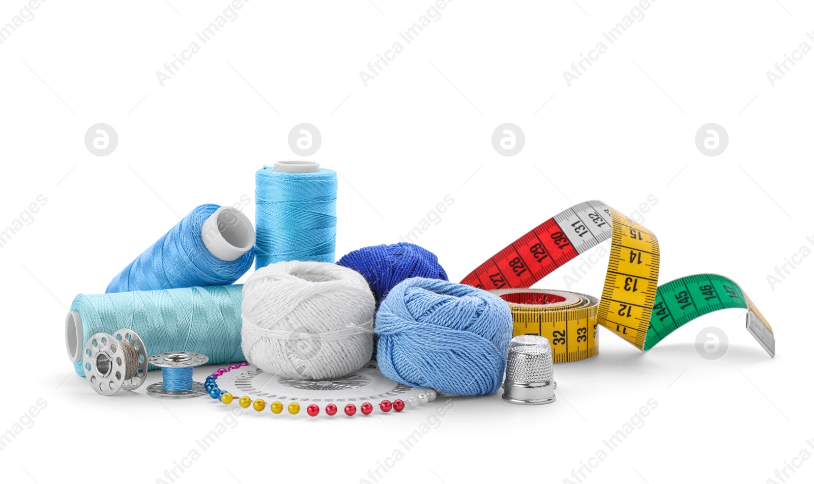 Photo of Color threads and sewing accessories on white background