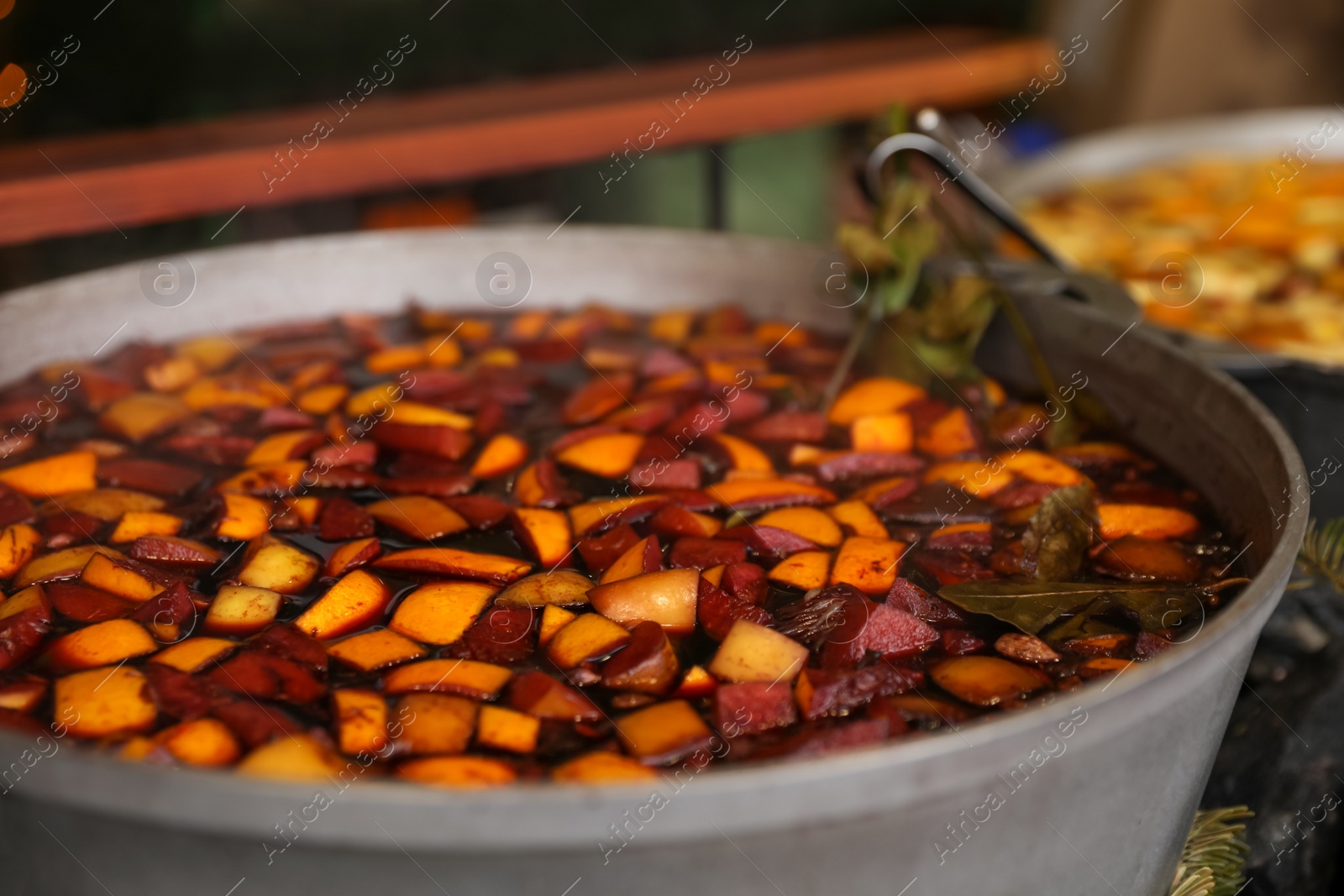 Photo of Big pot with mulled wine at Christmas fair stall, closeup