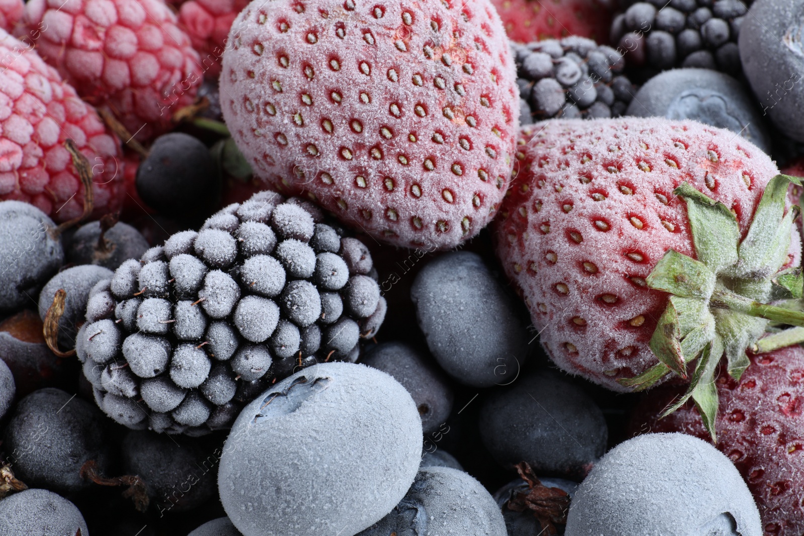 Photo of Mix of different frozen berries as background, top view