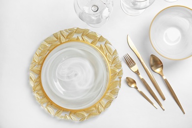 Elegant table setting on light background, top view