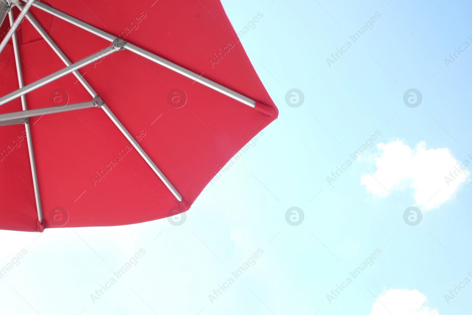 Photo of View of red umbrella and blue sky on sunny day