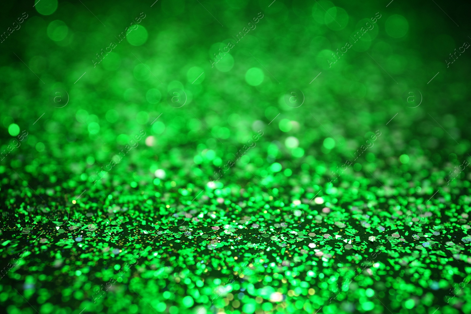 Image of St. Patrick day. Shiny green glitter, closeup. Bokeh effect