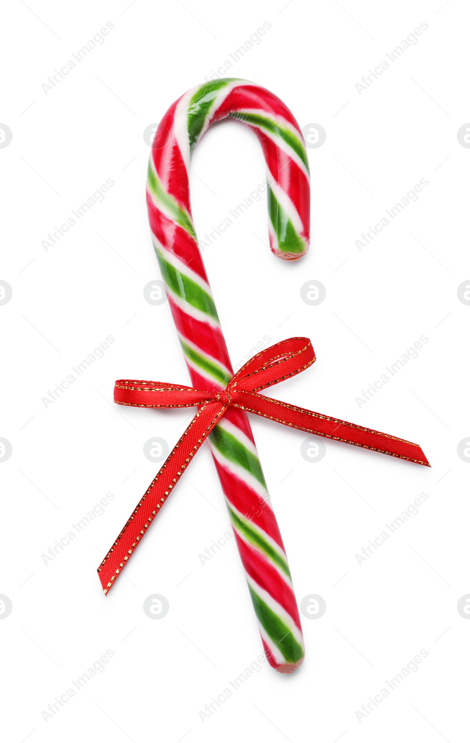 Photo of Sweet Christmas candy cane with red bow on white background