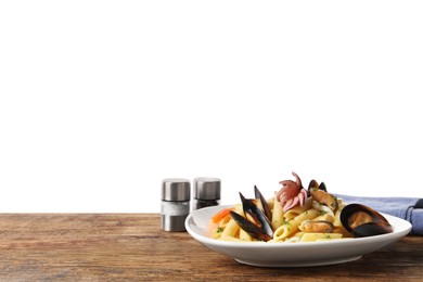 Delicious pasta with seafood served on wooden table against white background