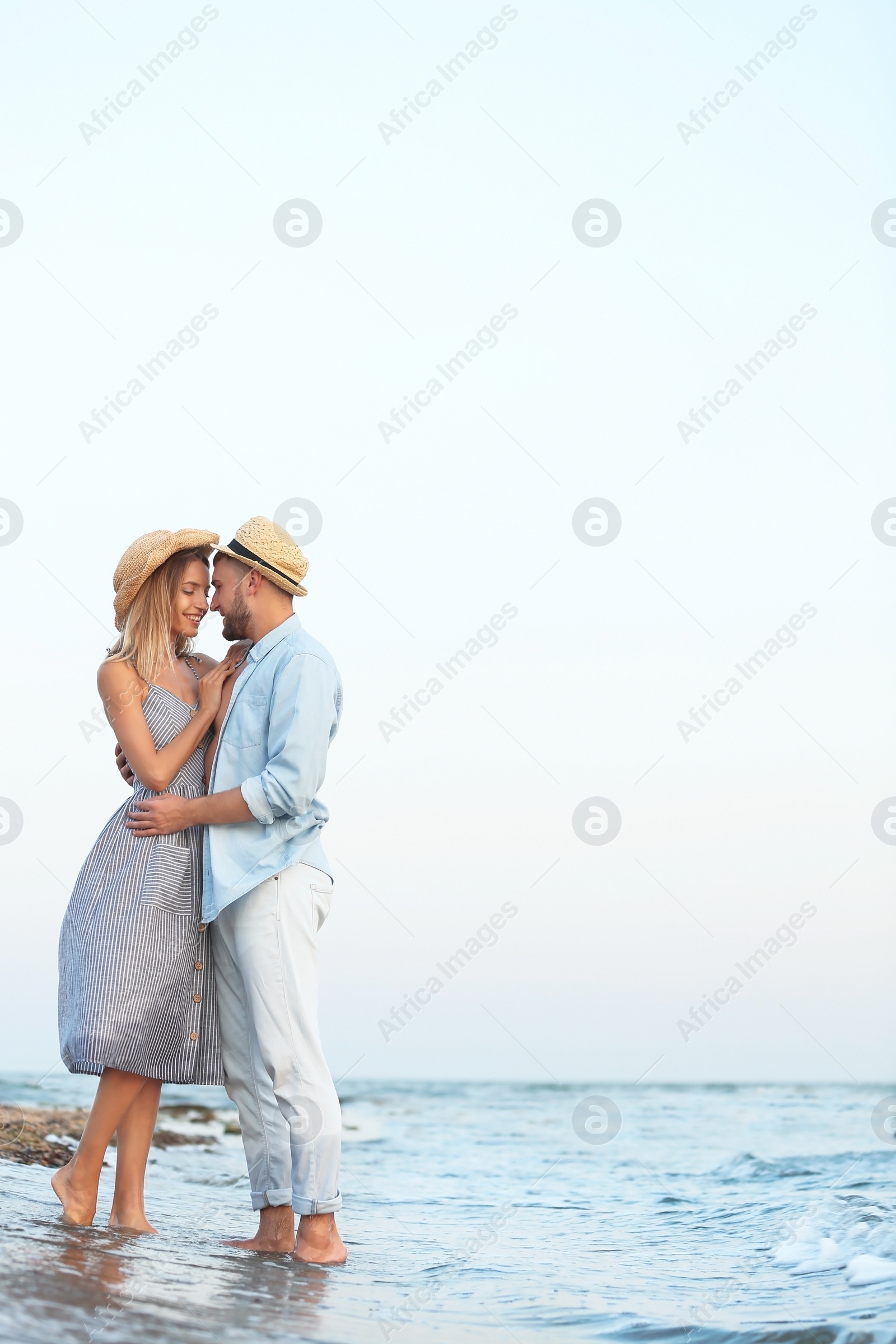 Photo of Young couple spending time together on beach