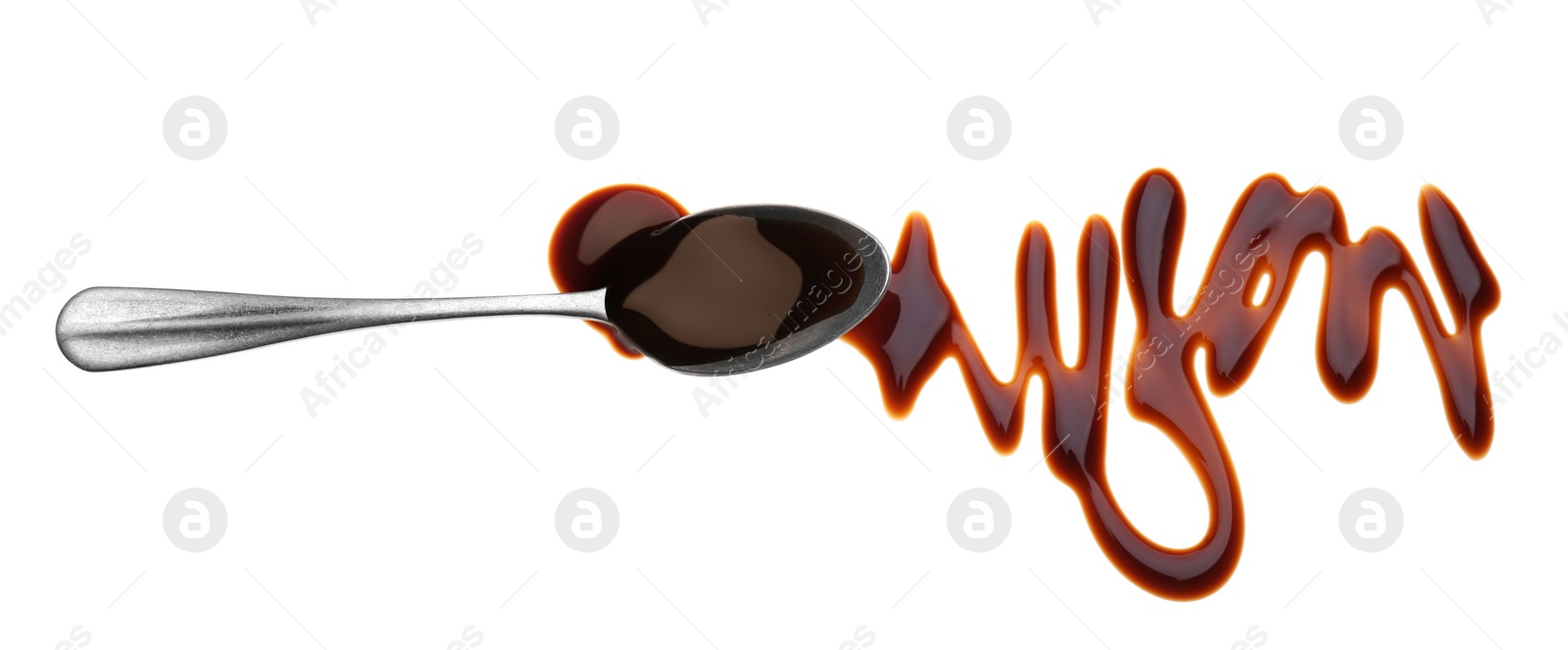 Photo of Smear of soy sauce and spoon on white background, top view