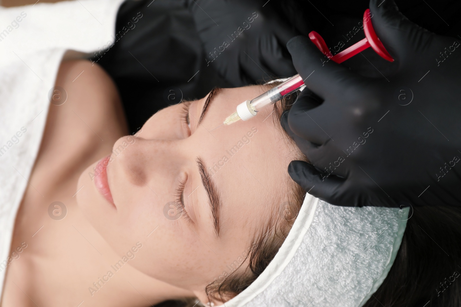 Photo of Cosmetologist giving facial injection to patient, closeup. Cosmetic surgery