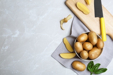 Flat lay composition with fresh organic potatoes on grey background