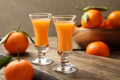 Delicious tangerine liqueur and fresh fruits on table
