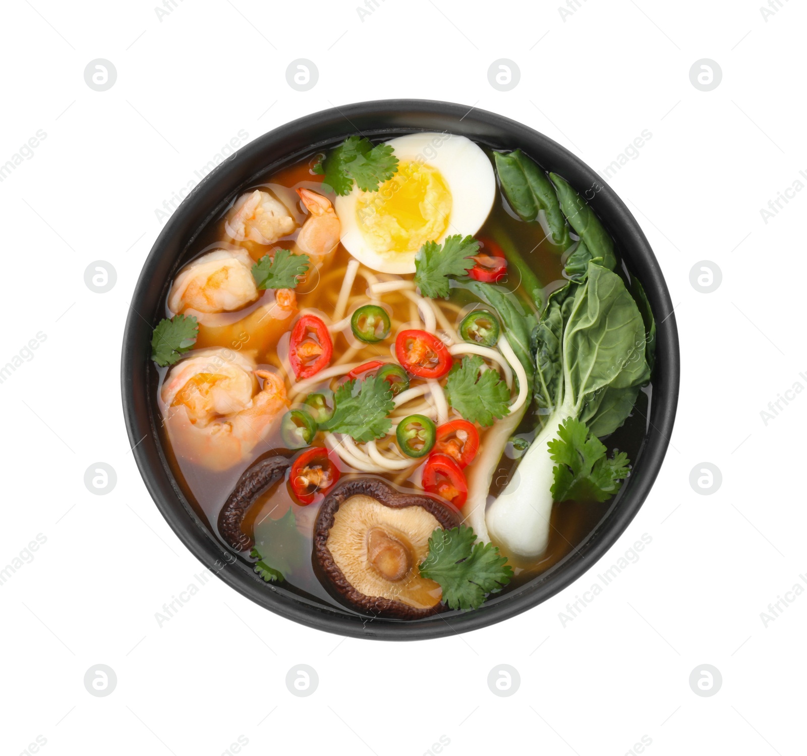 Photo of Delicious ramen with shrimps and egg in bowl isolated on white, top view. Noodle soup