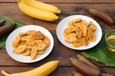 Tasty deep fried banana slices and fresh fruits on wooden table