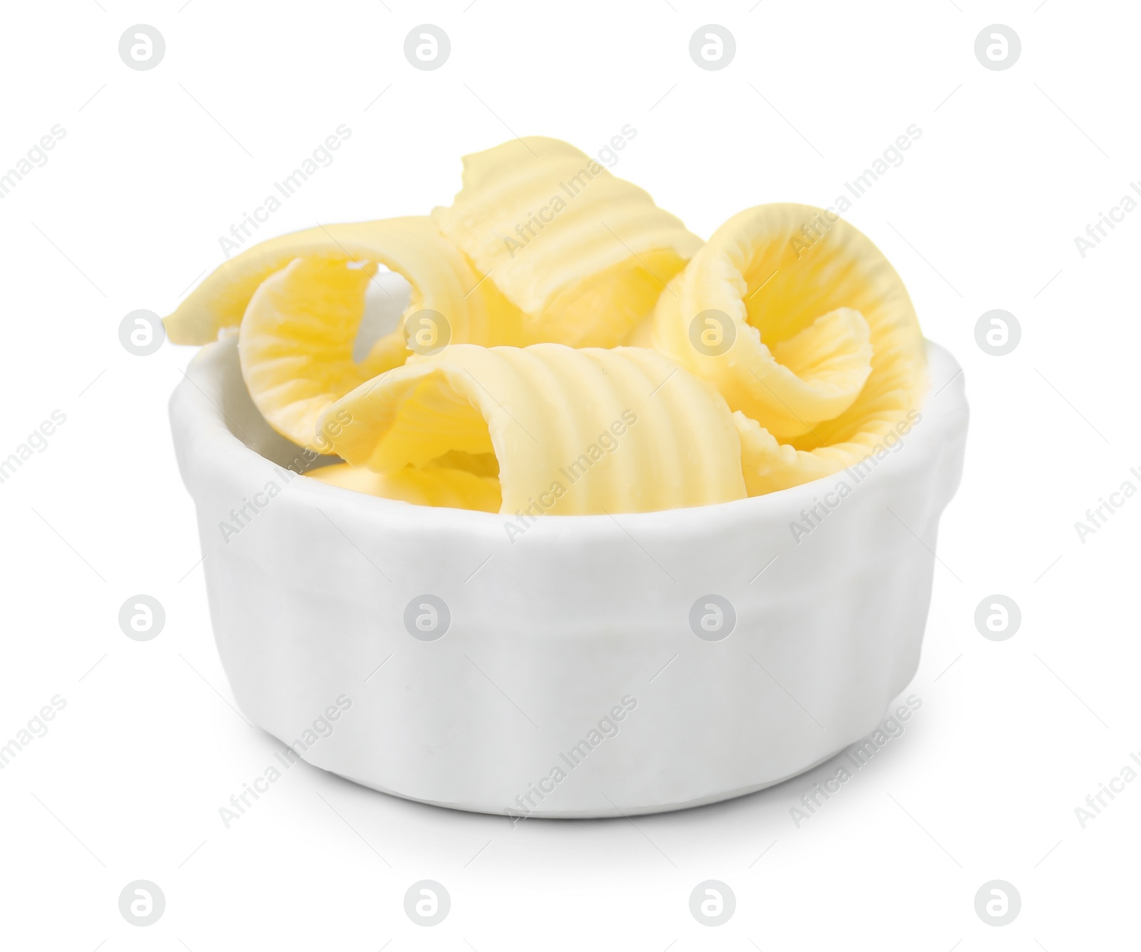 Photo of Tasty butter curls in bowl isolated on white