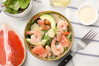 Photo of Delicious pomelo salad with shrimps served on light grey table, flat lay