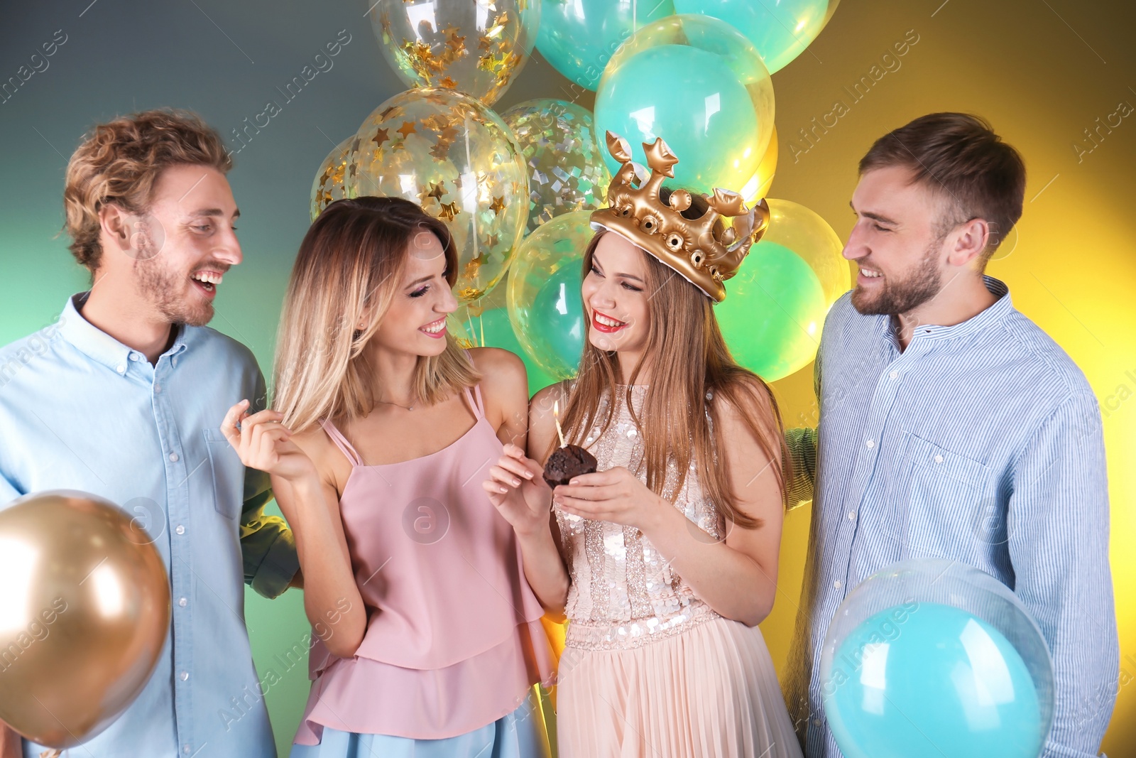 Photo of Friends with air balloons and muffin on color background. Birthday celebration