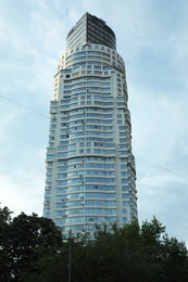 KYIV, UKRAINE - MAY 23, 2019: Modern dwelling building against sky with clouds