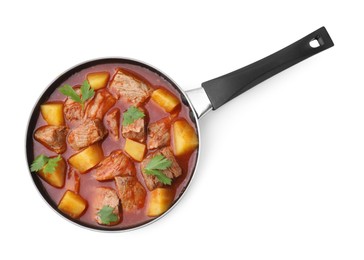 Photo of Delicious goulash in saucepan isolated on white, top view