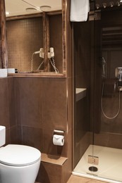 Photo of Stylish bathroom with toilet bowl in luxury hotel. Interior design