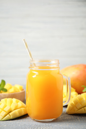 Photo of Fresh delicious mango drink on wooden table