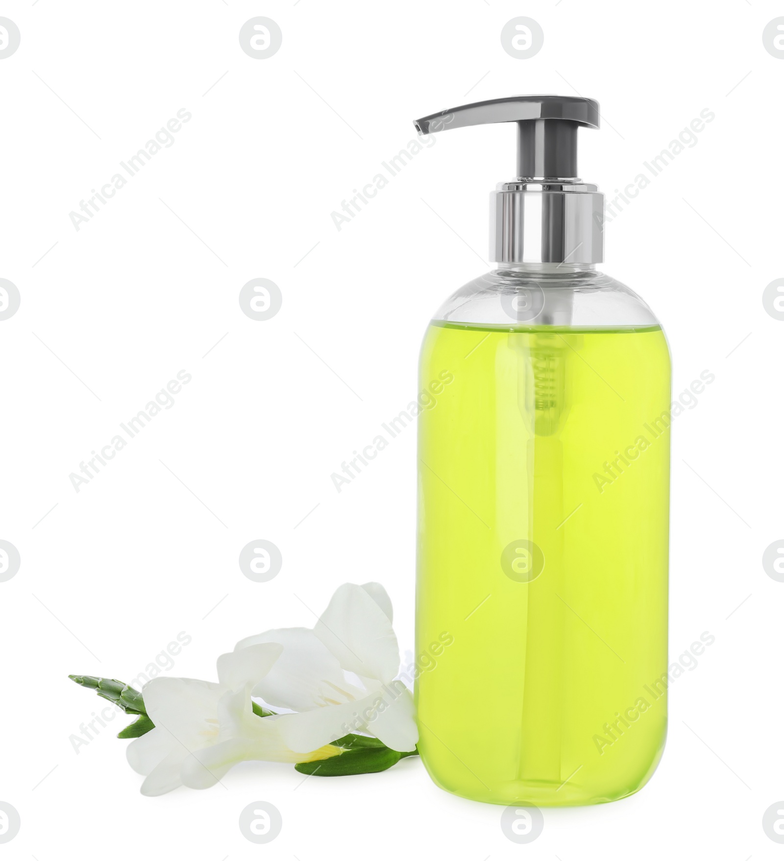 Photo of Dispenser of liquid soap and freesia flowers isolated on white