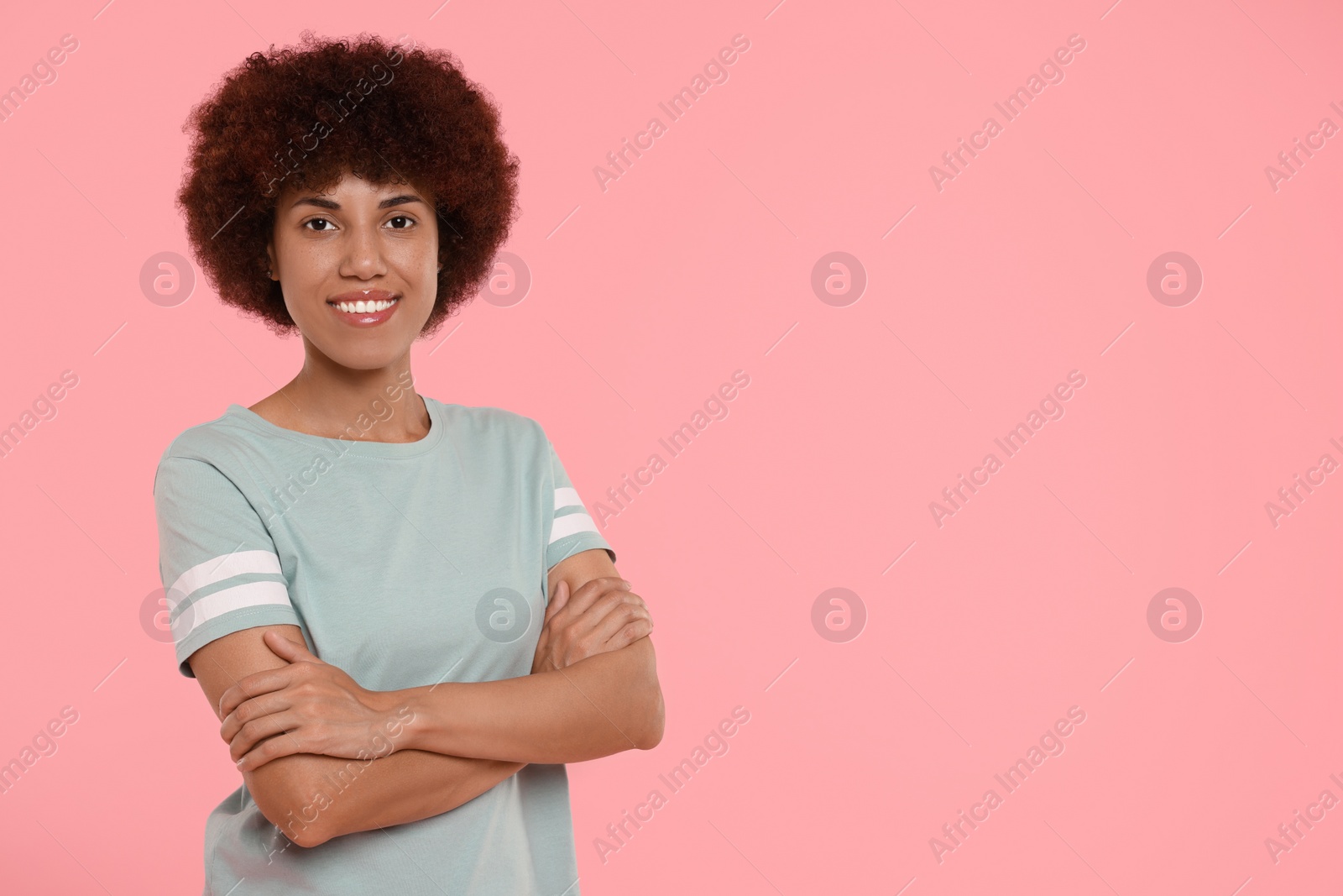 Photo of Portrait of happy young woman on pink background. Space for text