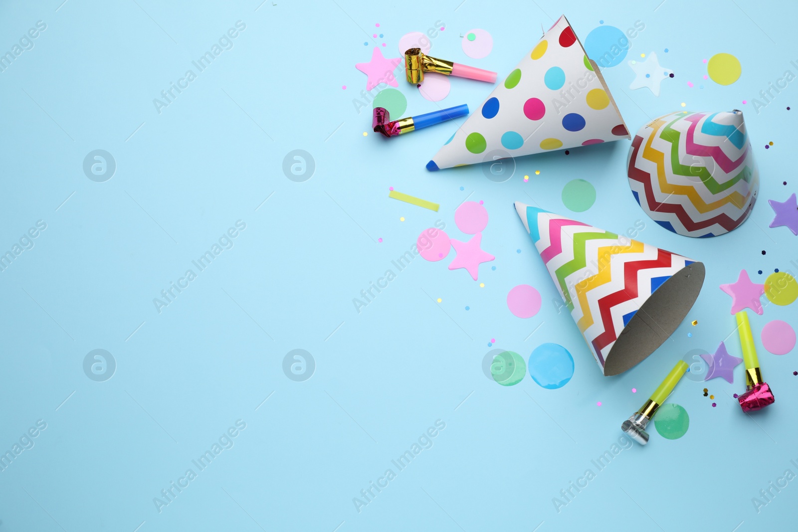 Photo of Flat lay composition with party items on light blue background, space for text