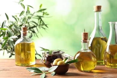 Photo of Composition with fresh olive oil on table