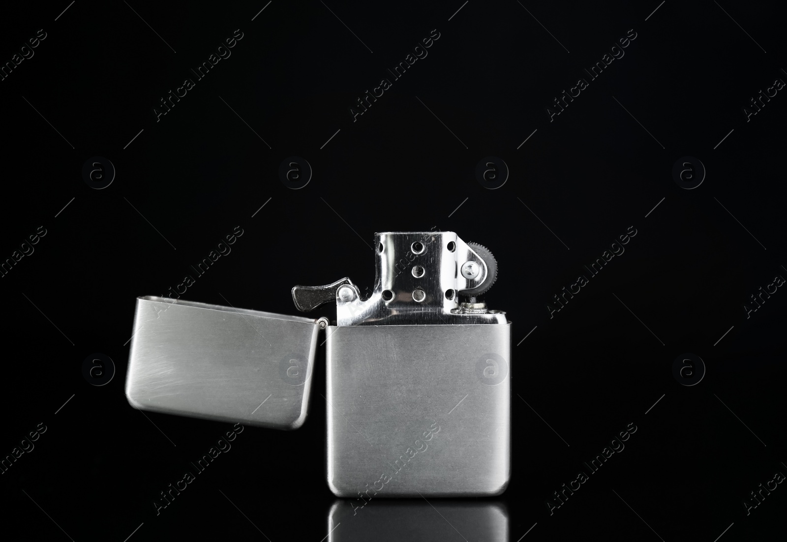 Photo of Gray metallic cigarette lighter on black background, closeup