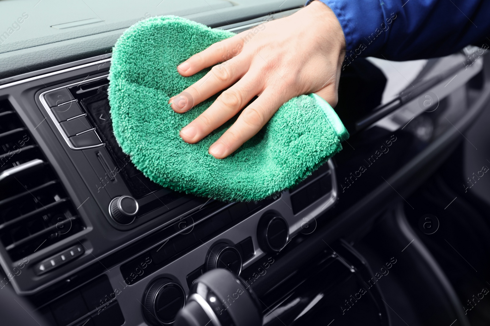 Photo of Car wash worker cleaning automobile interior, closeup