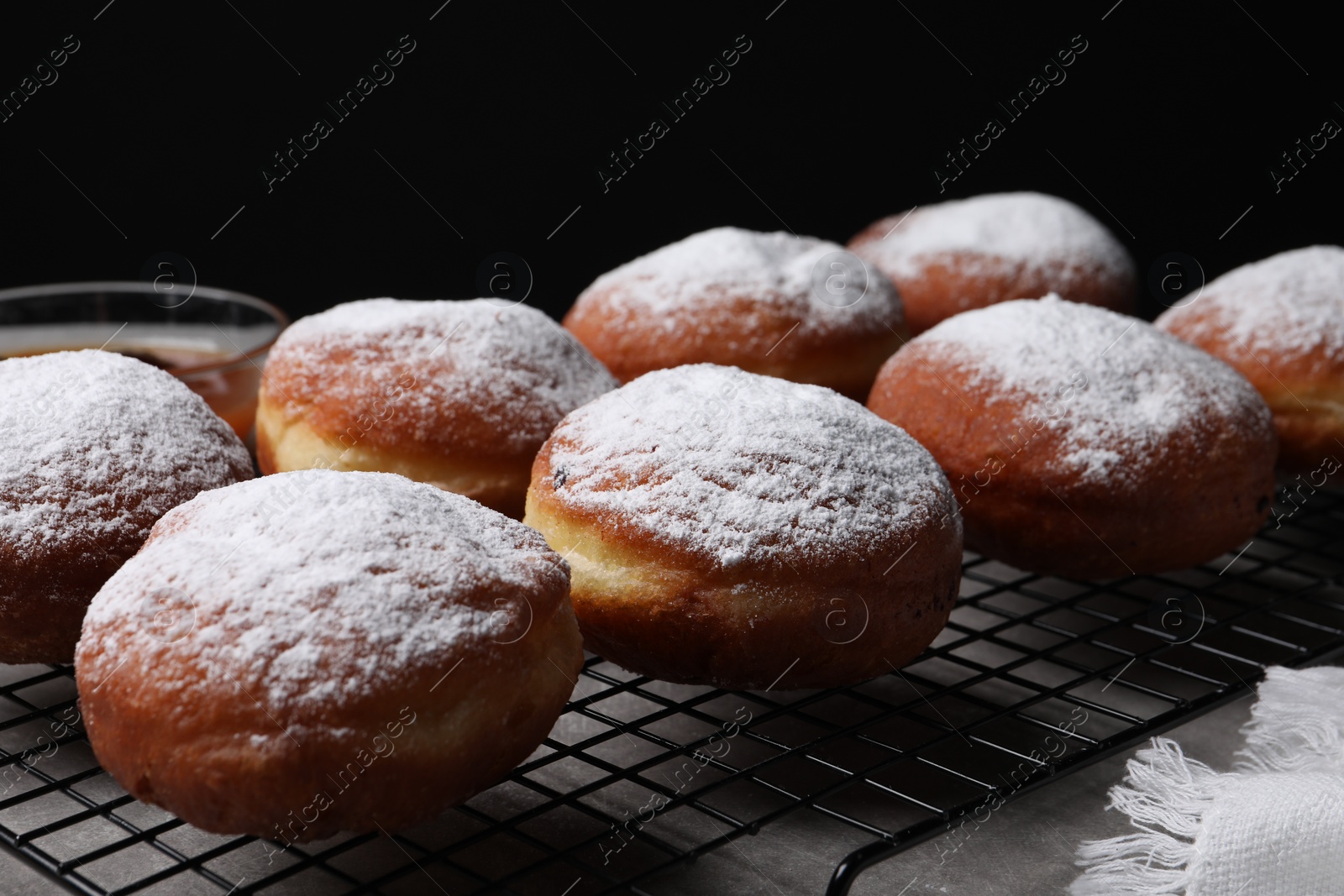 Photo of Delicious sweet buns on table against black background, closeup