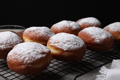 Photo of Delicious sweet buns on table against black background, closeup