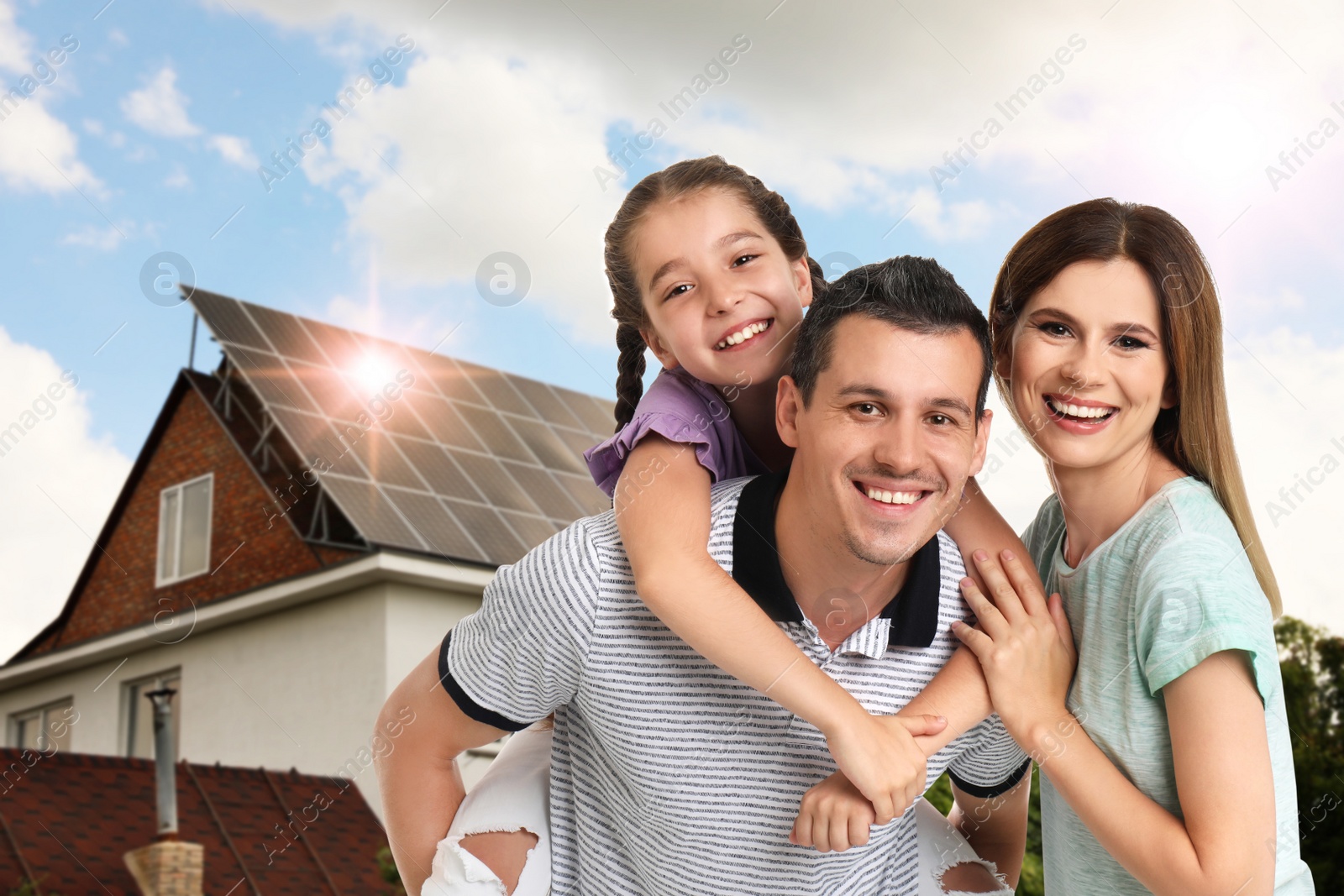 Image of Happy family near their house with solar panels. Alternative energy source