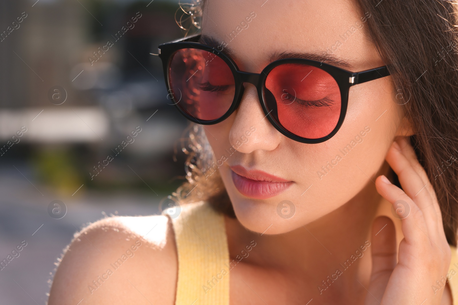 Photo of Beautiful woman in sunglasses outdoors, closeup. Space for text