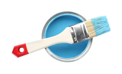 Photo of Can of light blue paint with brush isolated on white, top view